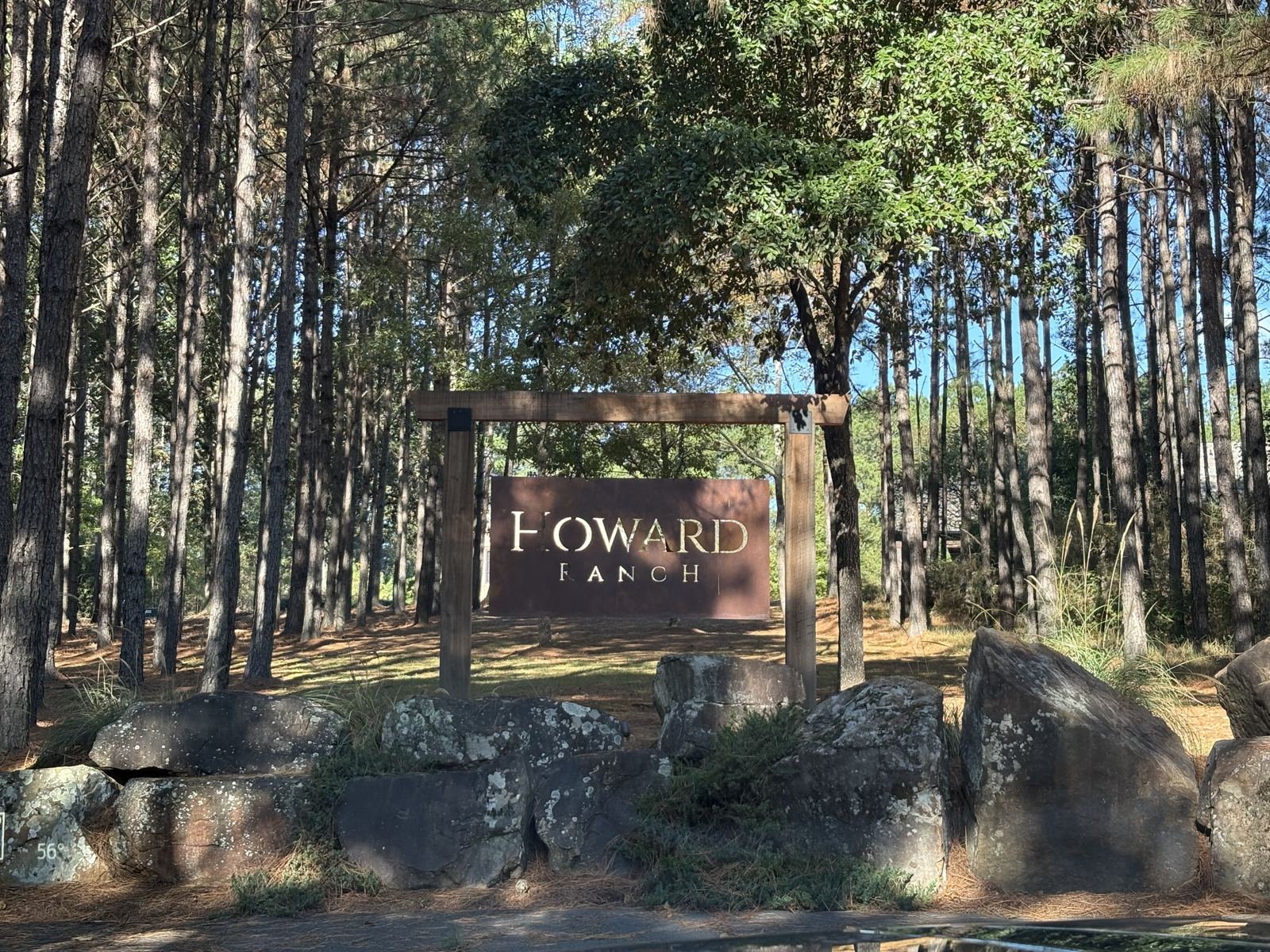 The Howard Ranch entrance sign among the pines